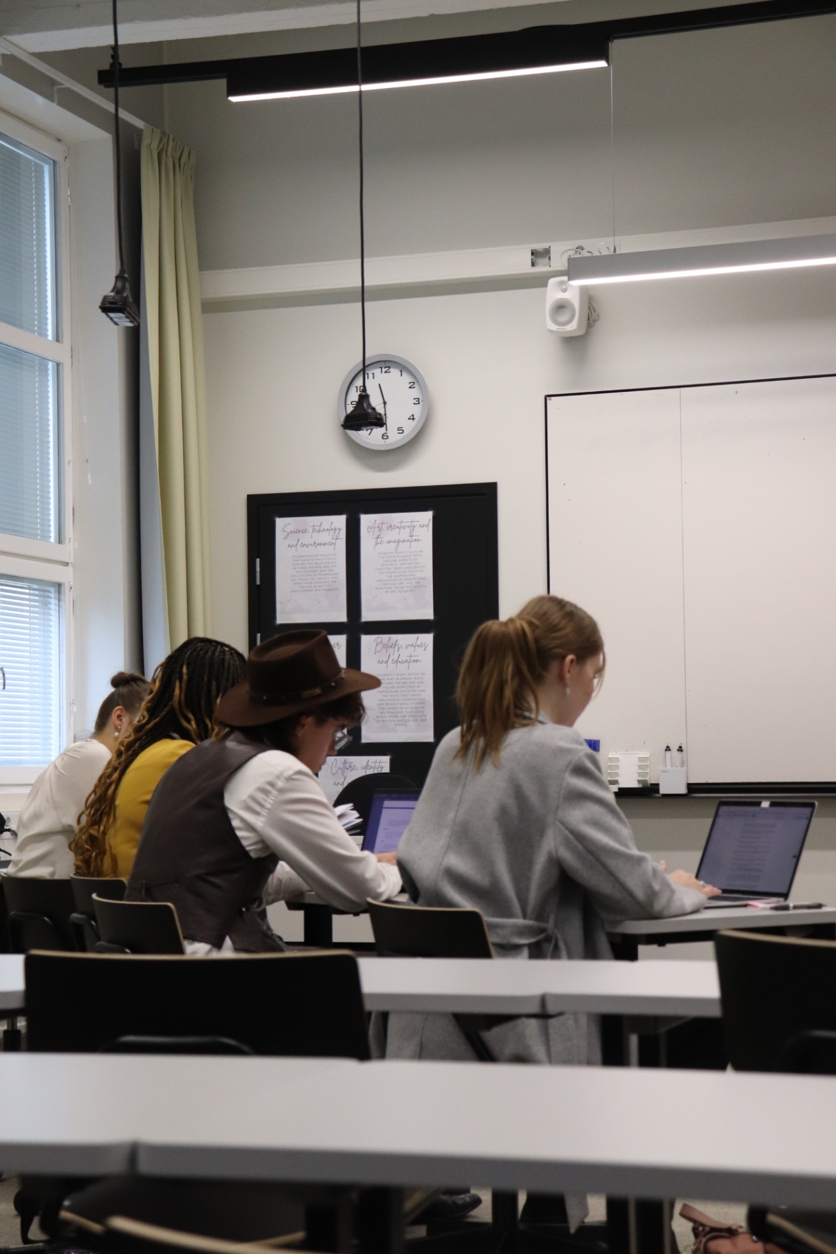 Team members preparing their case on laptops at HYMT 2024