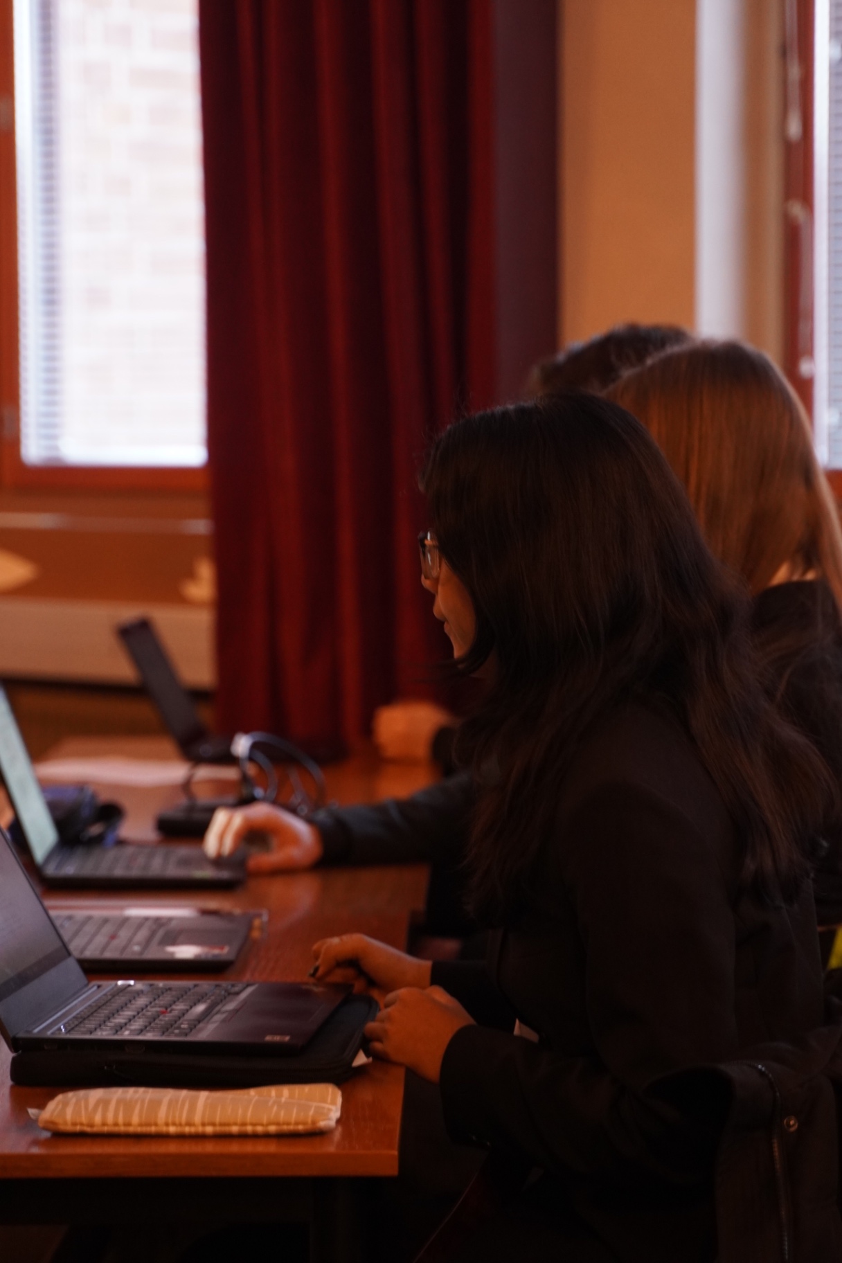 Team members preparing their case on laptops at HYMT 2026