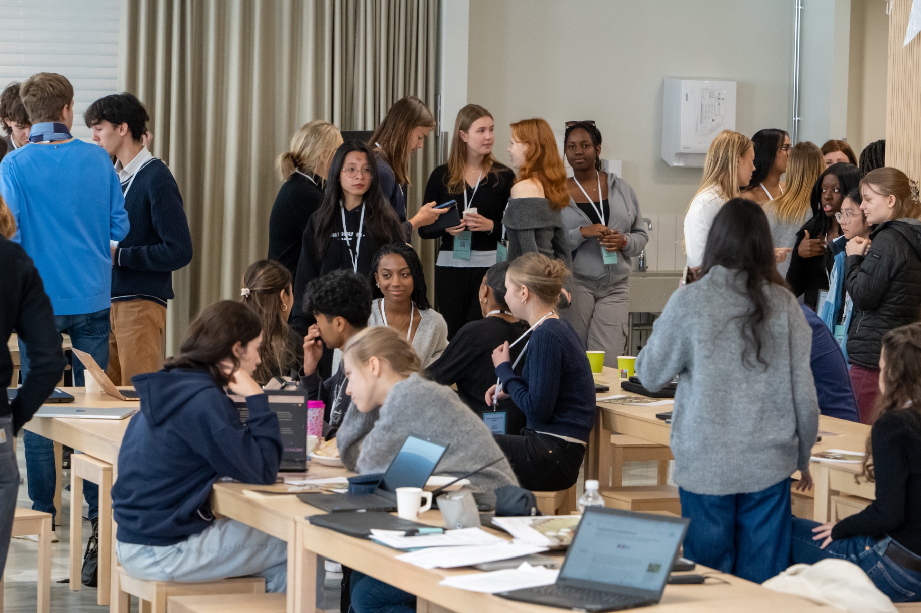 Delegates networking between rounds at HYMT 2024