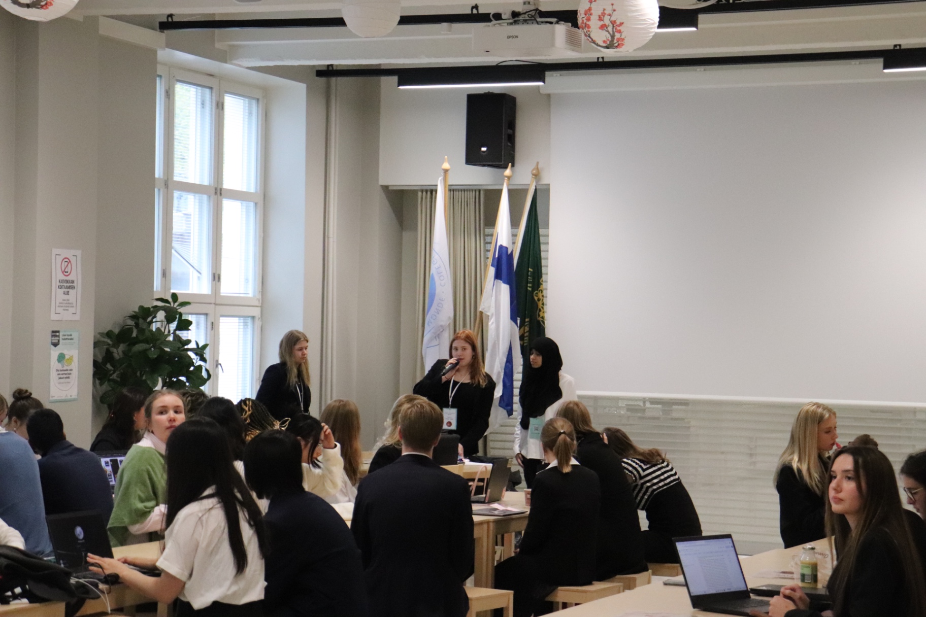 Organisers briefing delegates over the microphone at HYMT 2024