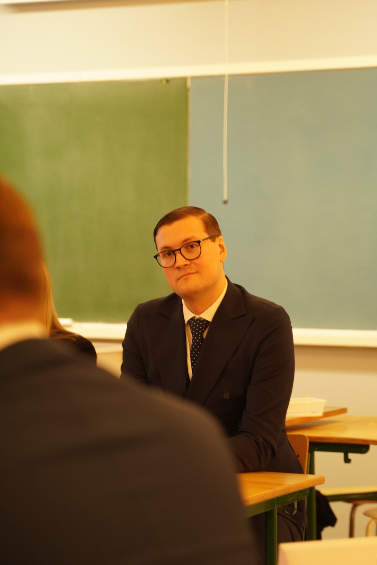 A volunteer judge listening to counsel at HYMT 2026